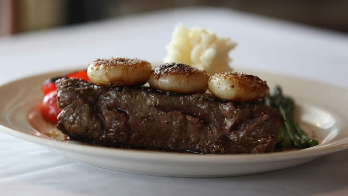 A closer look at Hutch's 12 oz. bison strip steak, grass fed from North Dakota with Tuscan herb sea salt and cippollini onions. (Sharon Cantillon/Buffalo News)